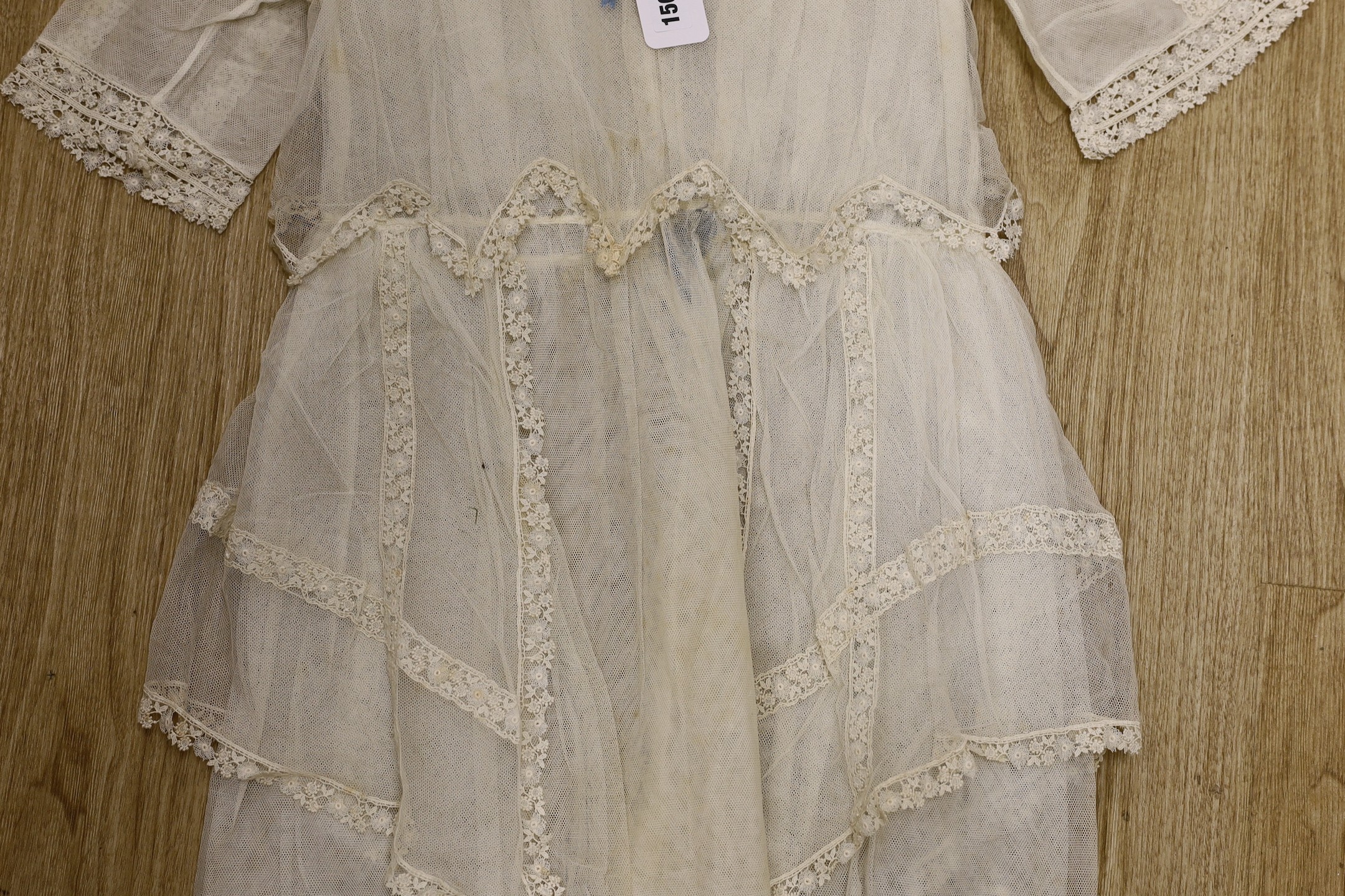 A young girl's 1920's-30's cream net and lace trimmed confirmation dress